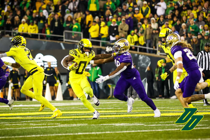 Oregon Ducks running back Bucky Irving uses a stiff arm against the Washington Huskies.